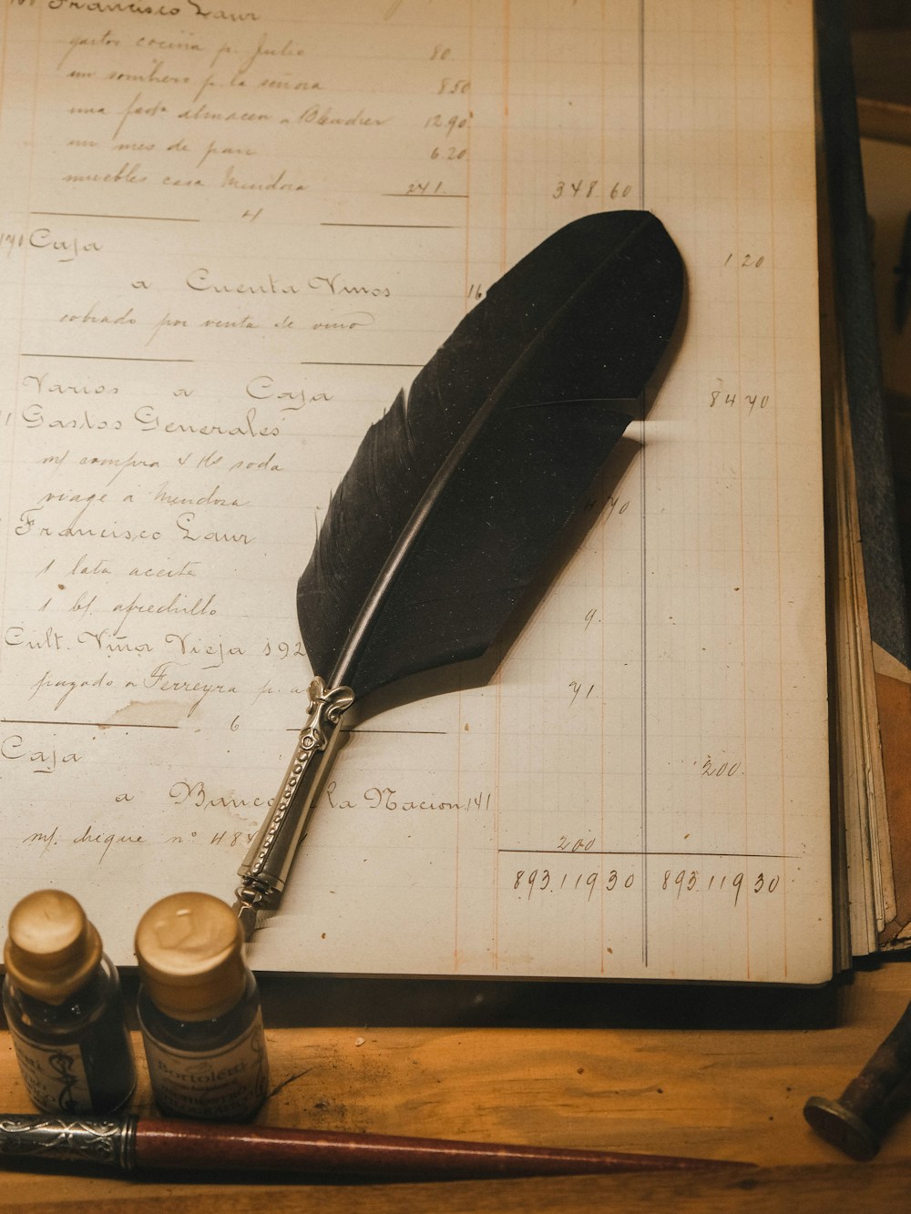 Pen resting on a hand-written ledger — the math, kept honestly.